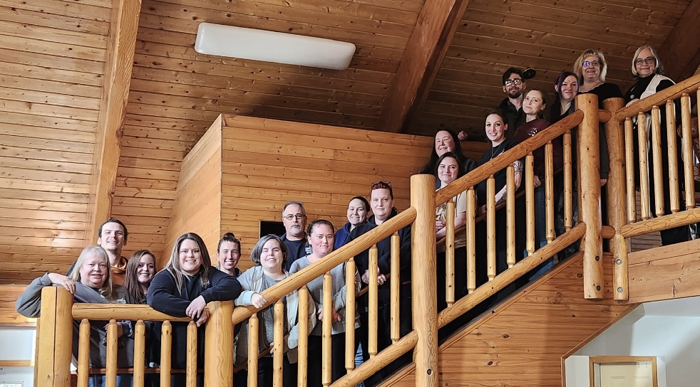 2023 OPHS Staff photo on wooden staircase