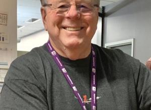 Kevin Talbot in Grey shirt wearing purple lanyard